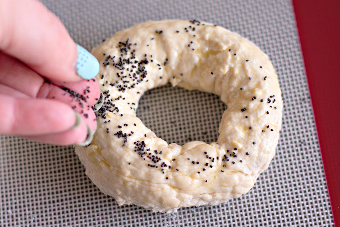 greek yogurt bagel on a baking sheet with seeds 