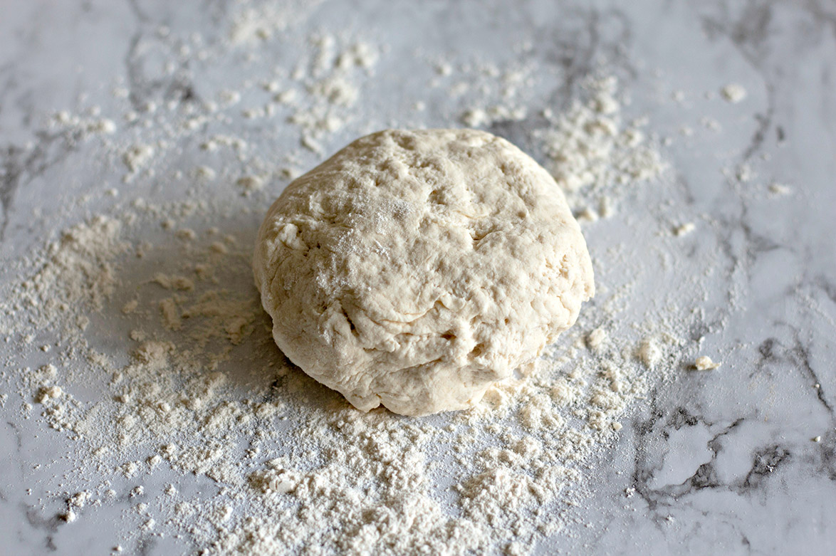 Greek yogurt bagel dough on a floured surface