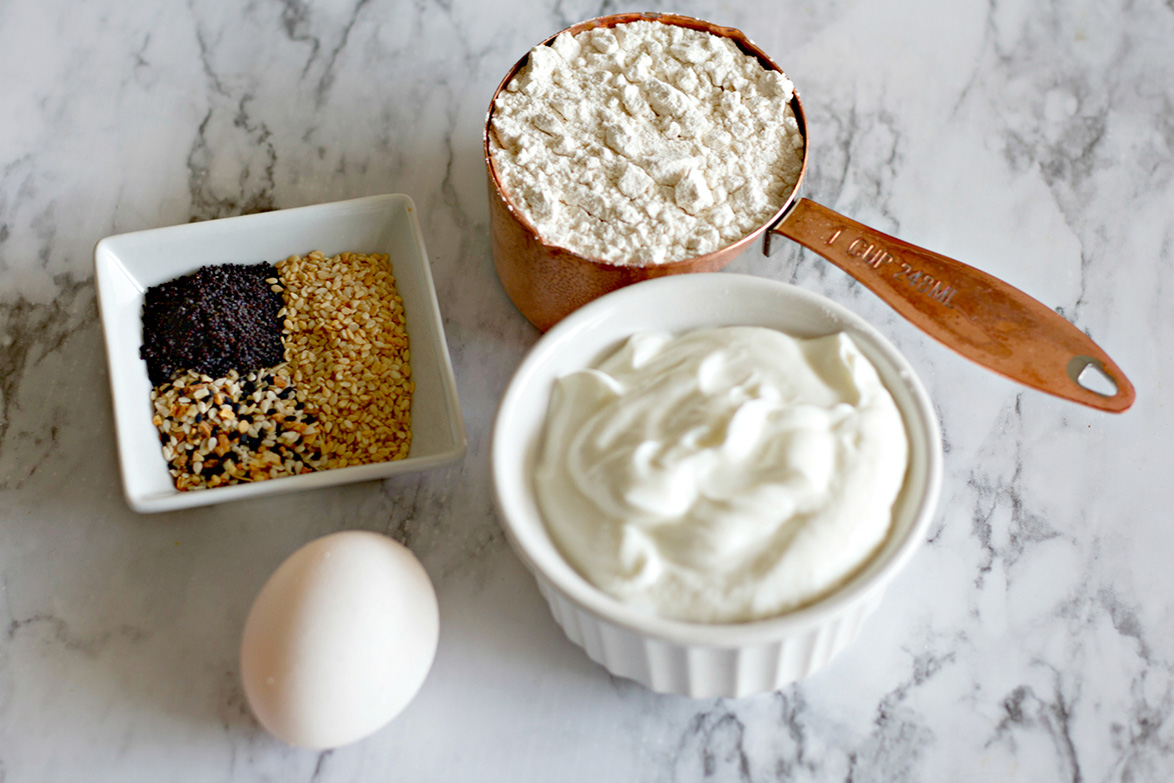 flour, yogurt, 1 egg, and seeds in small bowls.