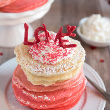 pink ombre pancakes on a white plate