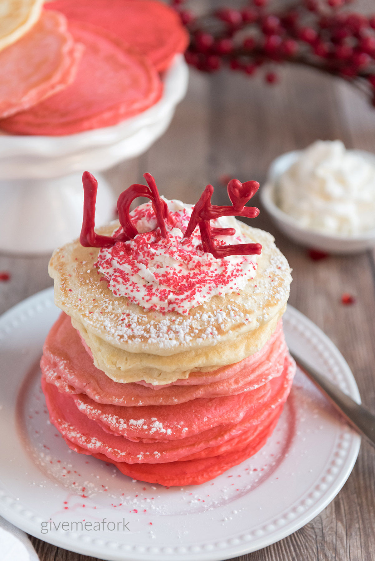 pink ombre pancakes on a white plate 