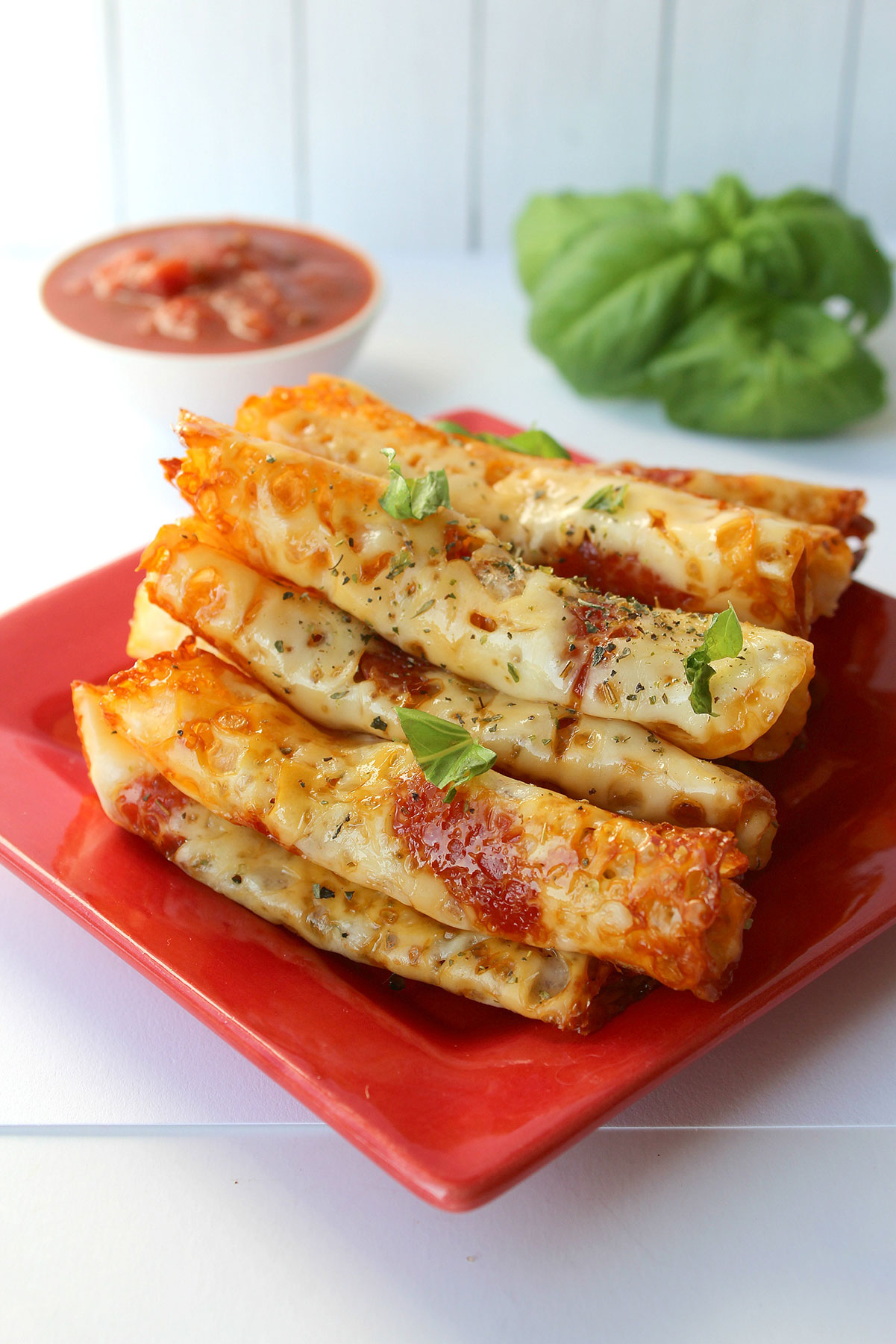 keto pepperoni pizza rolls on a red plate 