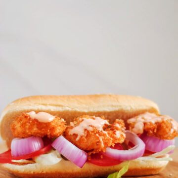 shrimp po'boy sandwich on a wooden board