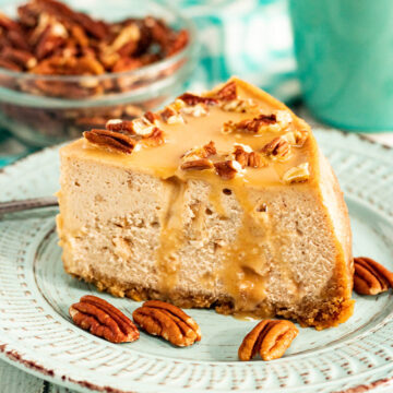 a slice of caramel apple cheesecake with pecans.