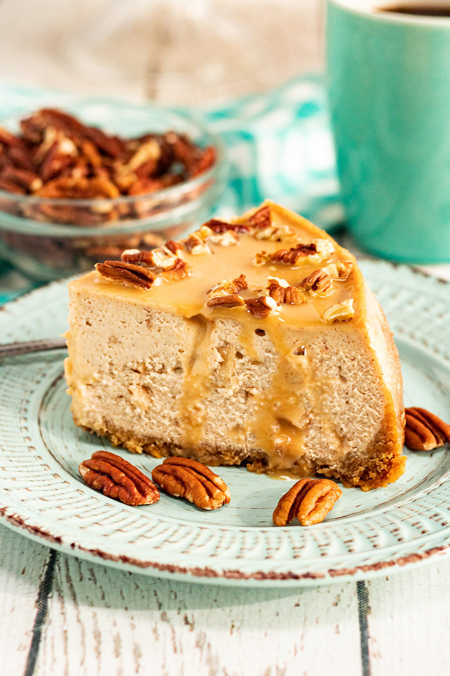 a slice of caramel apple cheesecake with pecans. 