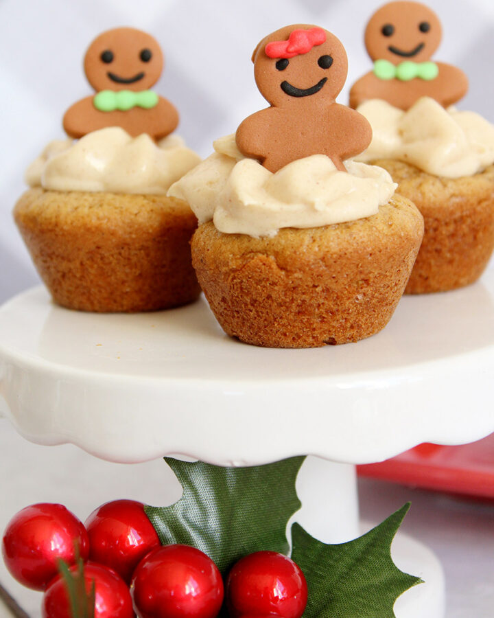 three gingerbread cheesecake cookie cups on a white cake stand.