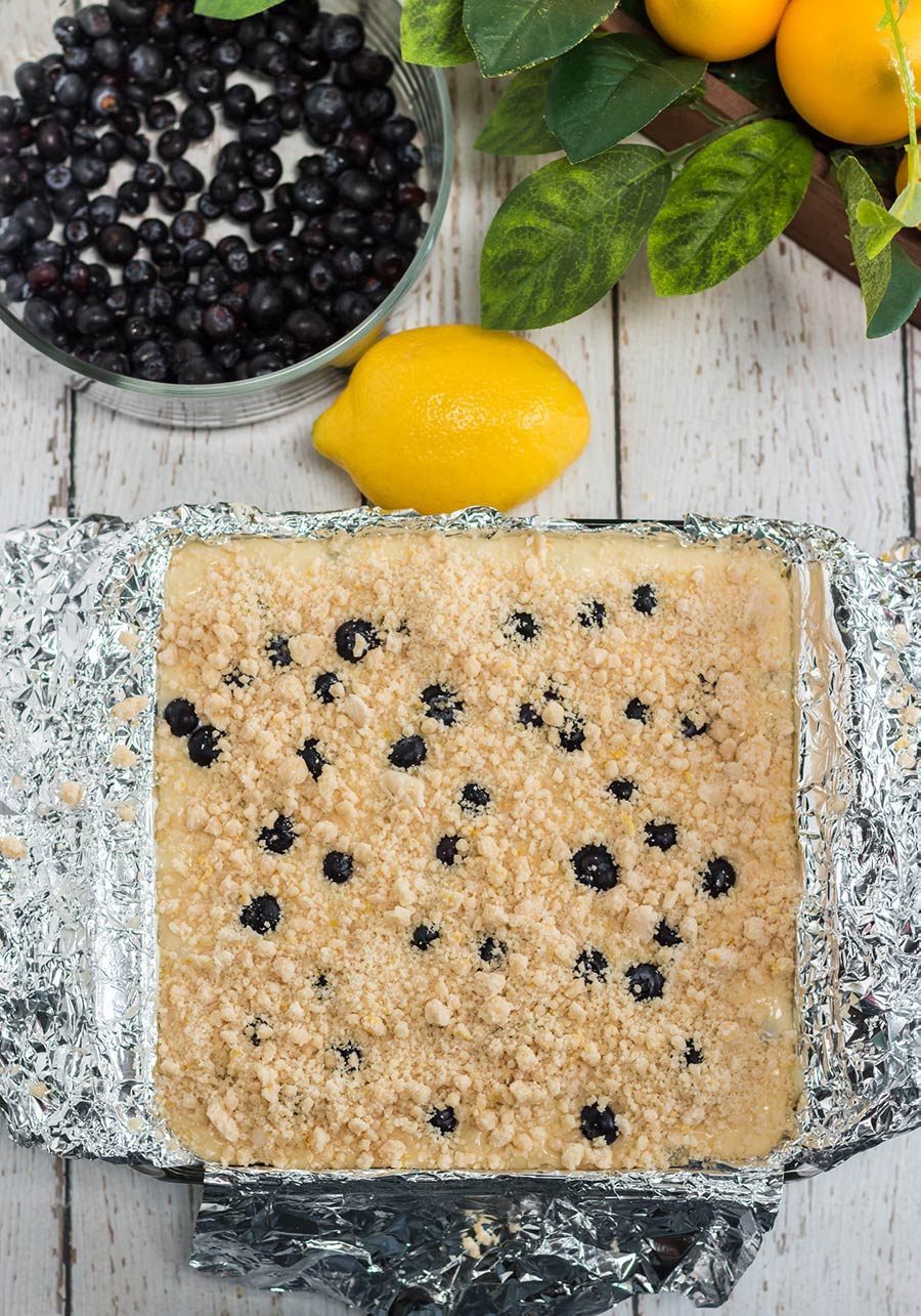 cake in a baking dish with a lemon and blueberries on the side. 