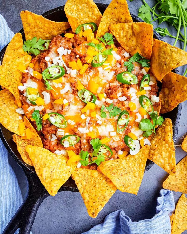 ground beef nachos in a cast iron skillet.