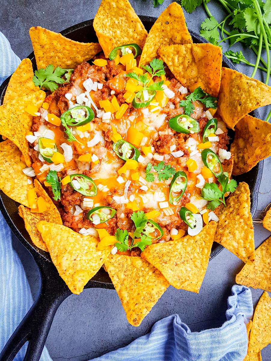 ground beef nachos in a cast iron skillet.