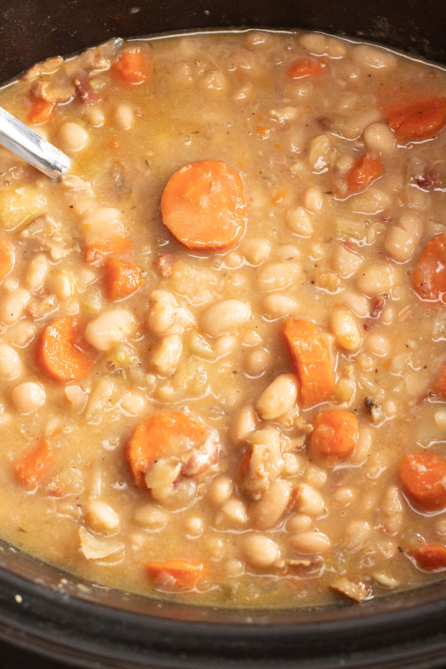 bacon and bean soup in the crockpot up close. 