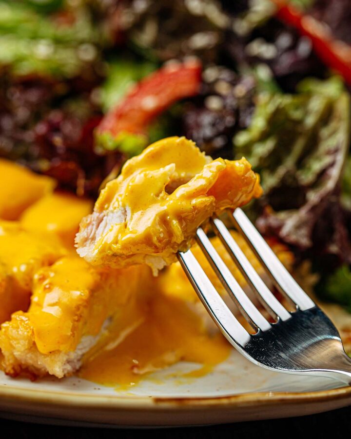 gluten free chicken curry on a plate with a fork.