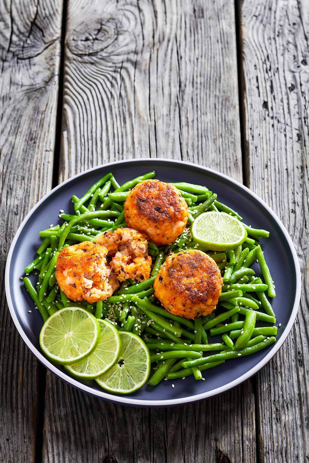 Phillips crab cakes with green beans and lime wedges. 