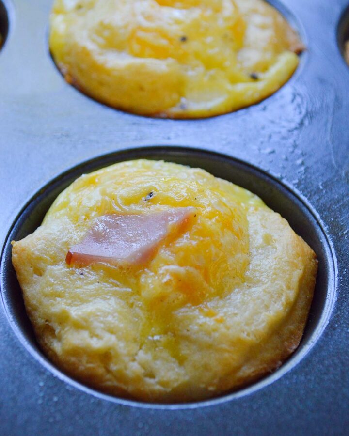 ham and cheese egg cup in a muffin tin up close.