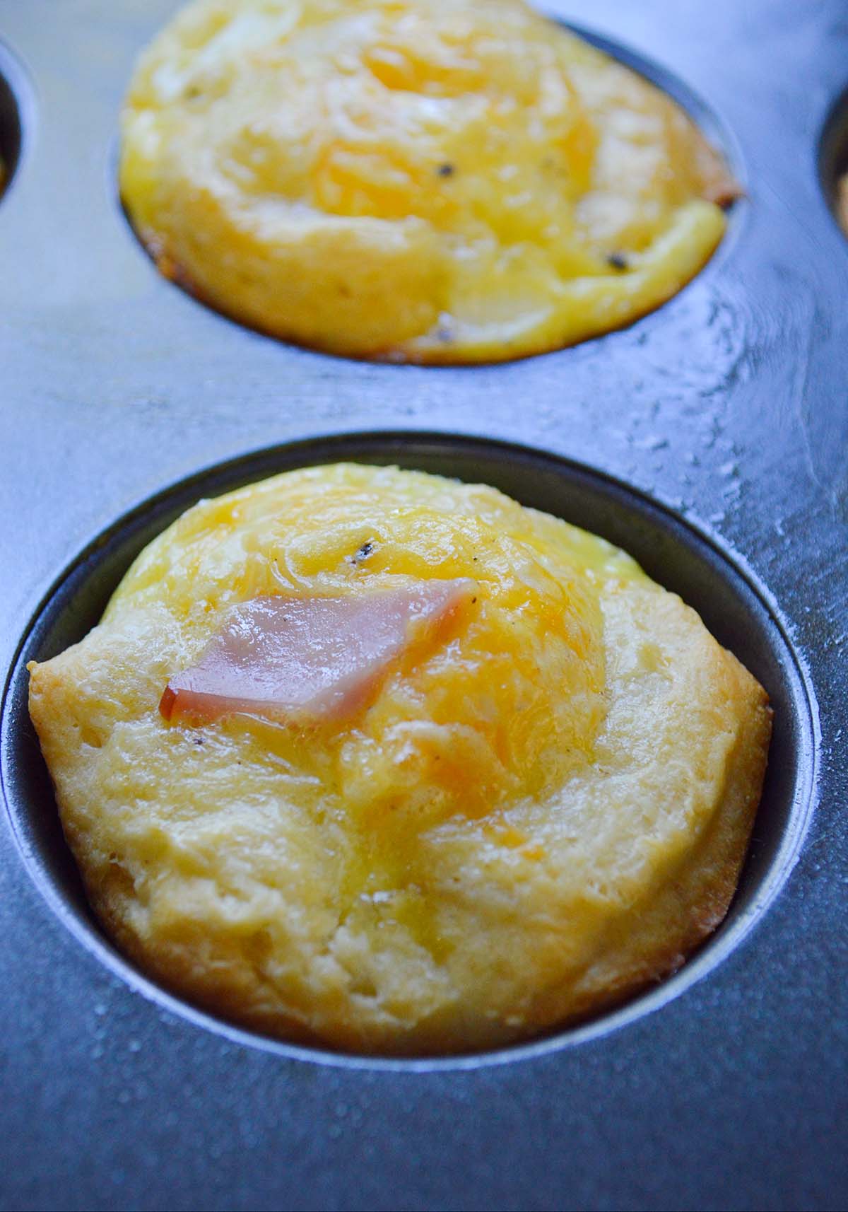 ham and cheese egg cup in a muffin tin up close. 