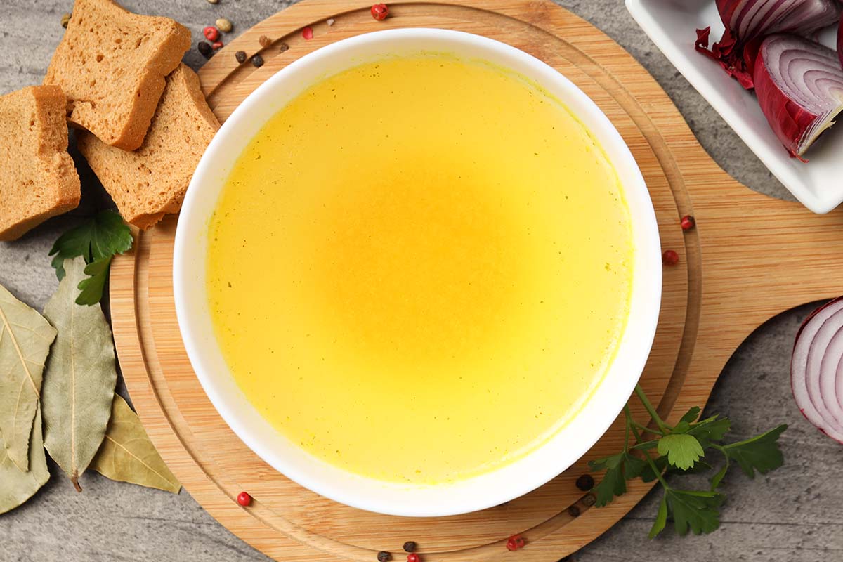 chicken stock in a white bowl.