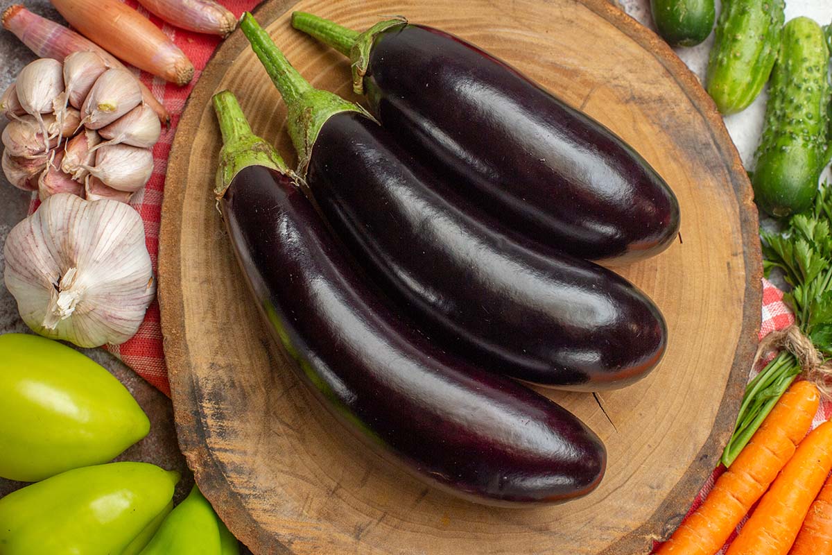 three eggplants with veggies on the side. 
