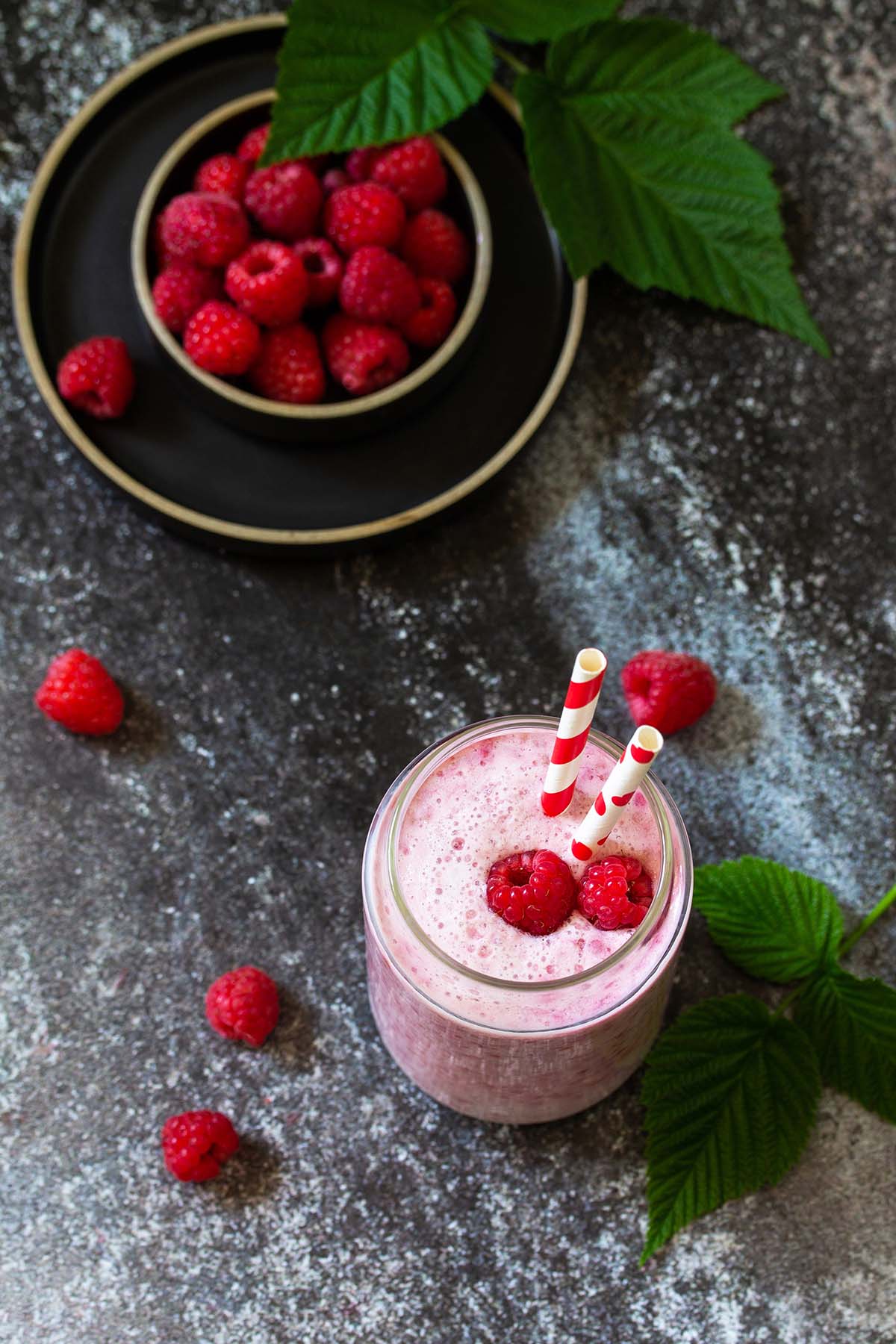 raspberry milkshake with two straws. 