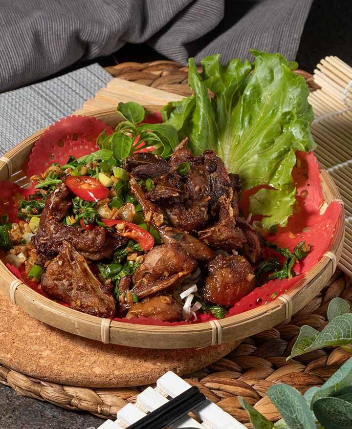 grilled dove in a bowl with lettuce on the side.