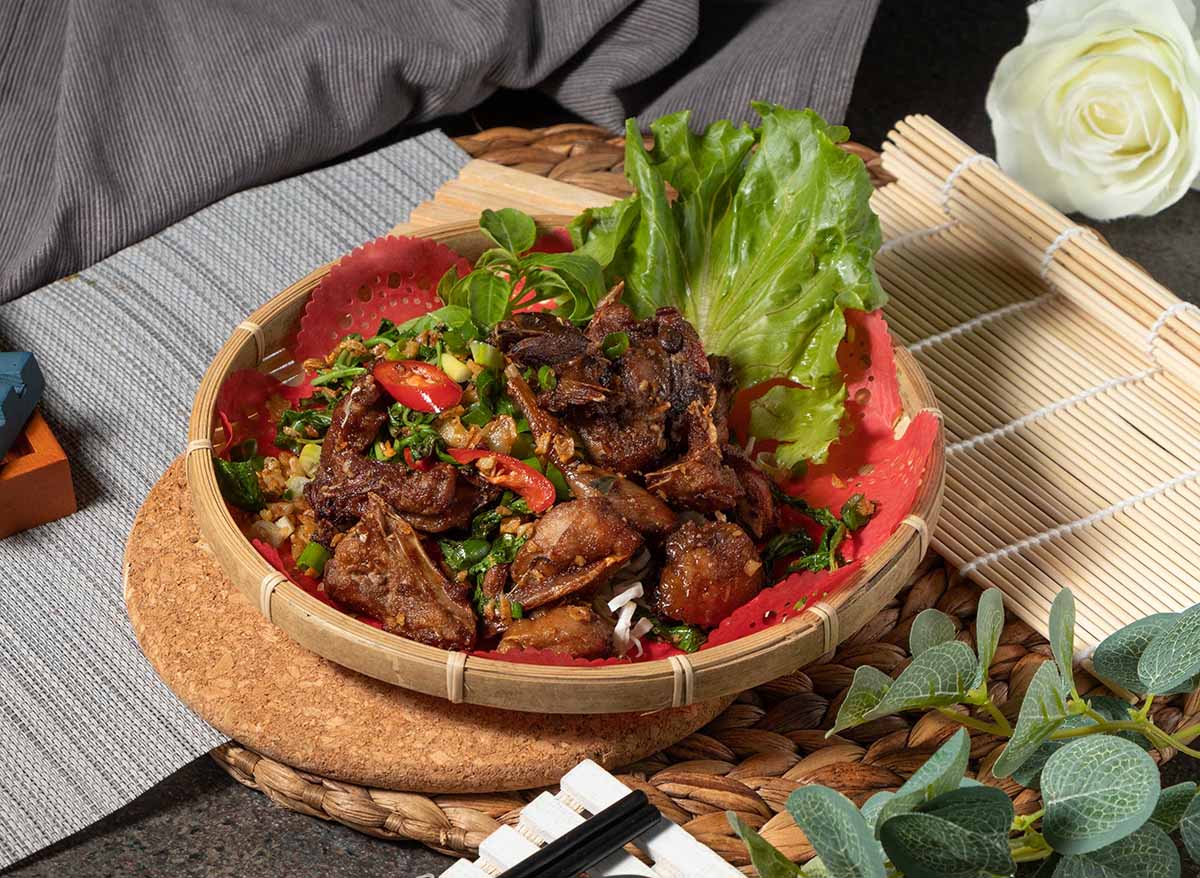 grilled dove in a bowl with lettuce on the side. 