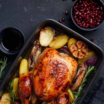 low carb whole chicken with rosemary and garlic on the side.