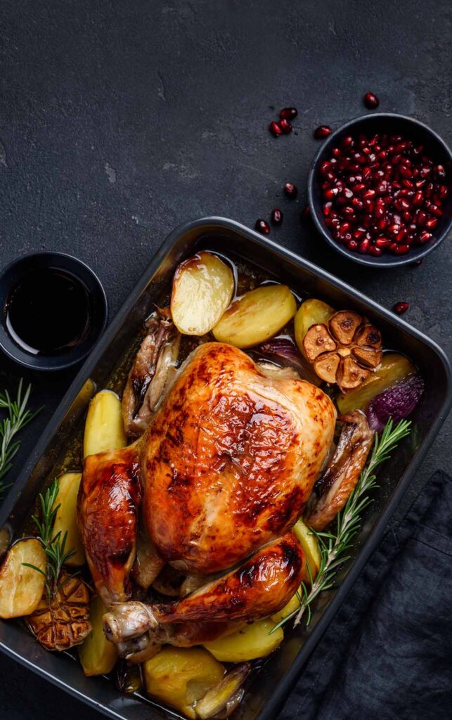 low carb whole chicken with rosemary and garlic on the side.