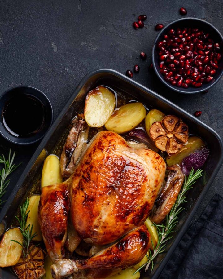 low carb whole chicken with rosemary and garlic on the side.