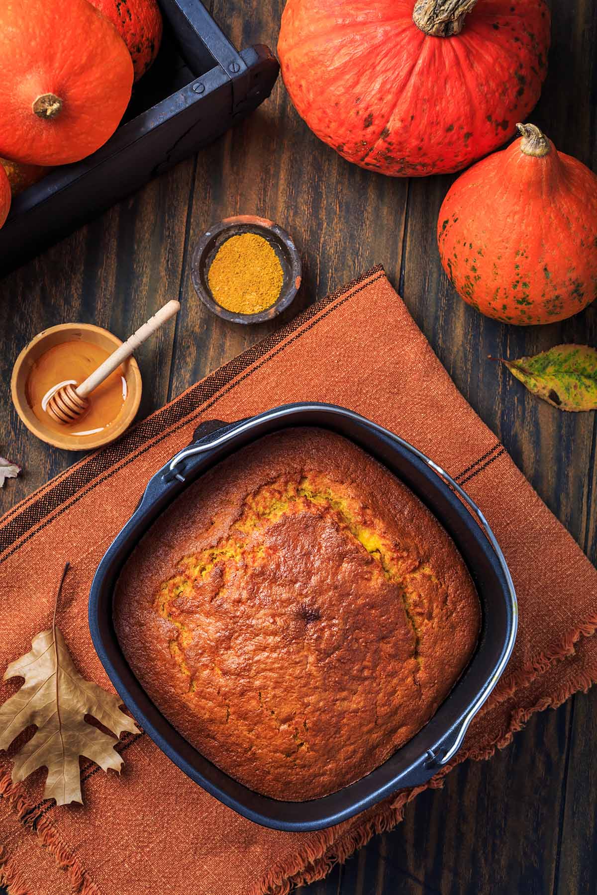 cooked cornbread with honey on the side.