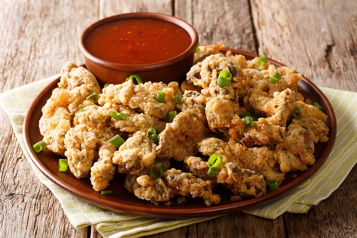 air fryer chicken gizzards on a plate up close.