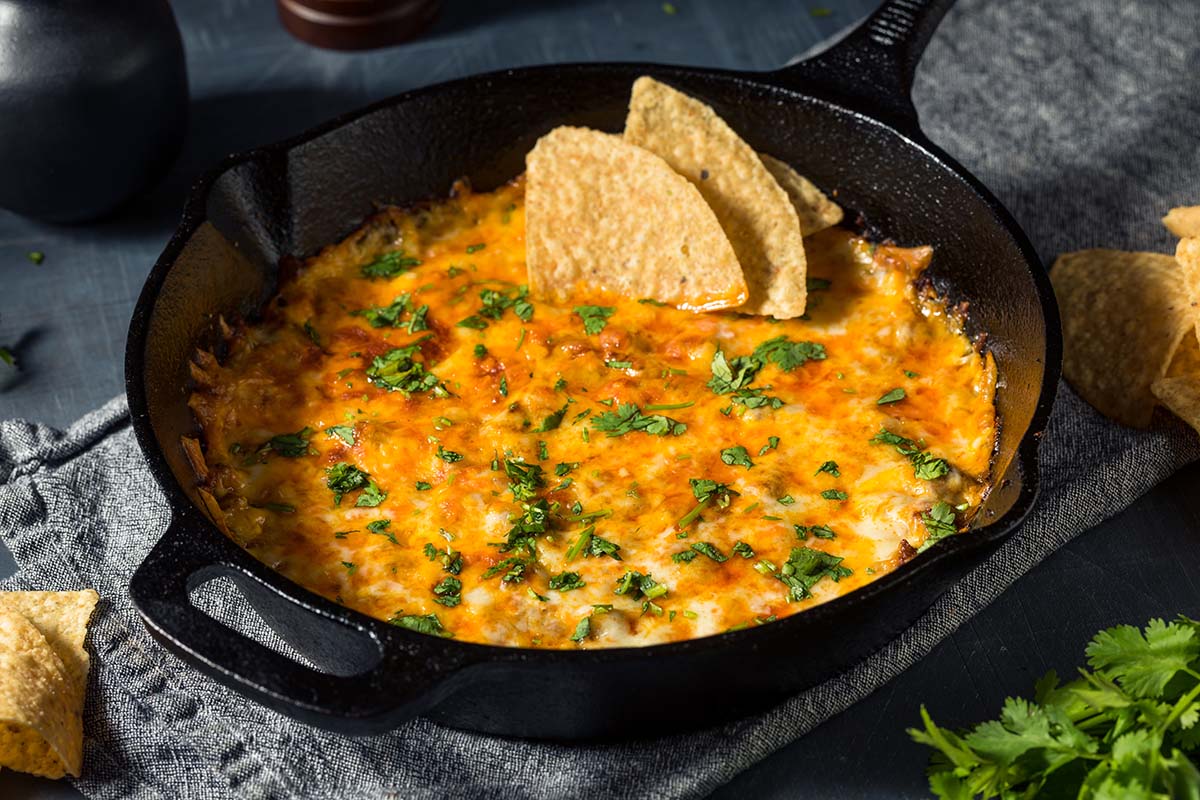 oaxaca queso dip in a cast iron skillet. 