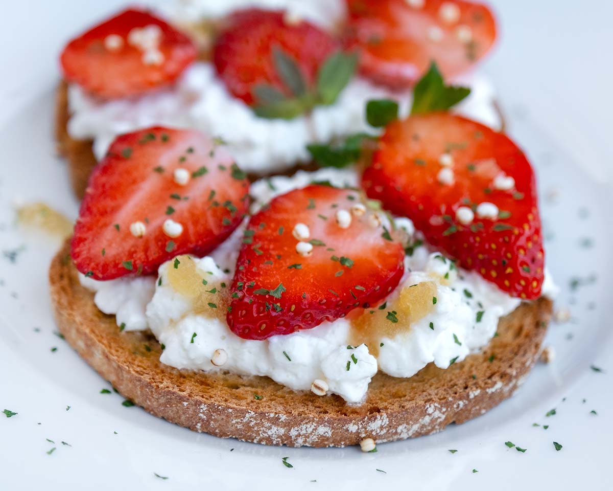 whipped cottage cheese on toast with strawberries on toast.