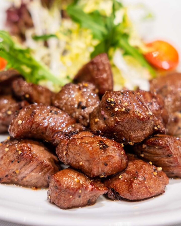 beef cubes with salad on the side.