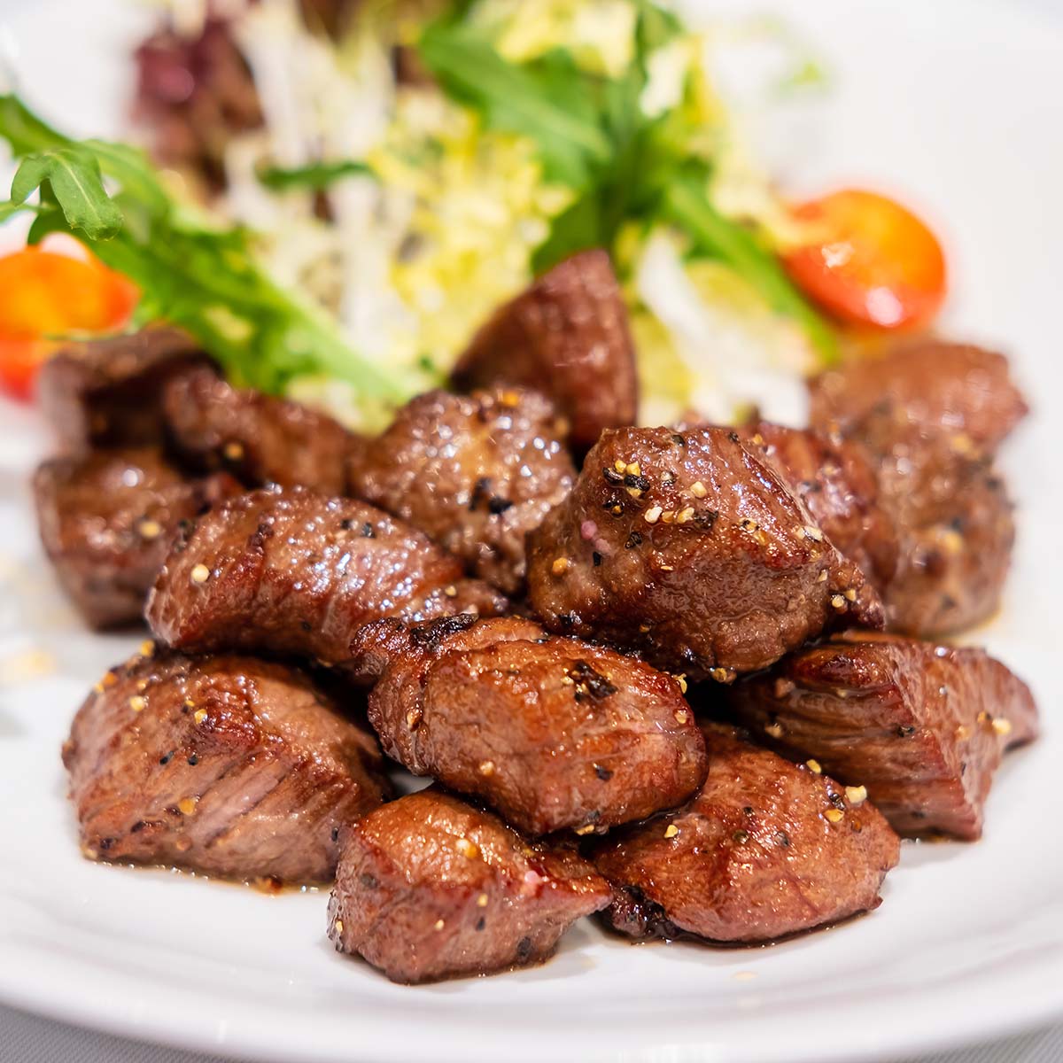 beef cubes with salad on the side. 