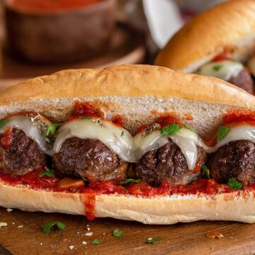 ground pork meatball sandwich with cheese and sauce.