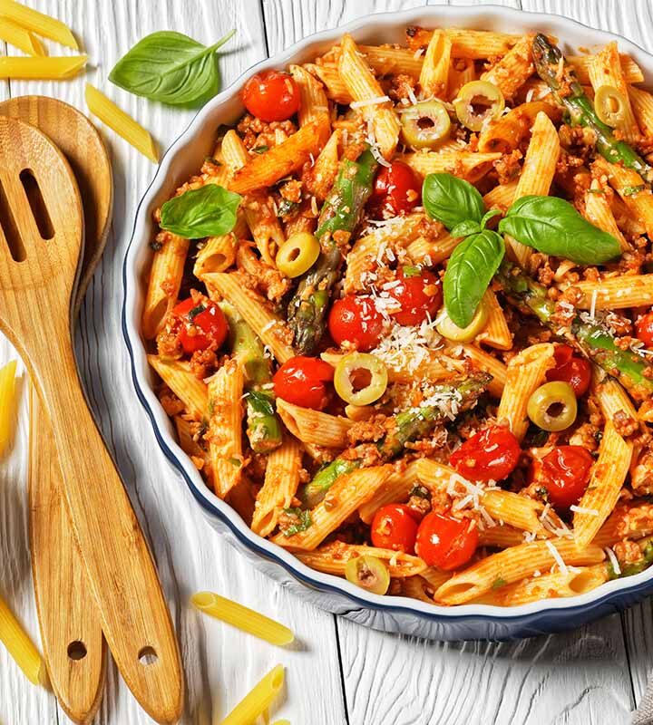 ground turkey pasta in a white bowl with wooden spoons on the side.