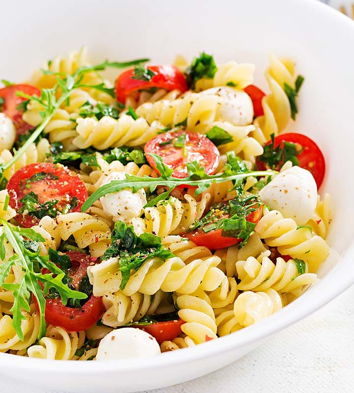 high protein pasta salad in a white bowl.