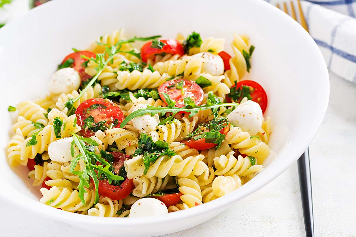 high protein pasta salad in a white bowl. 