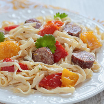 kielbasa pasta on a white plate.