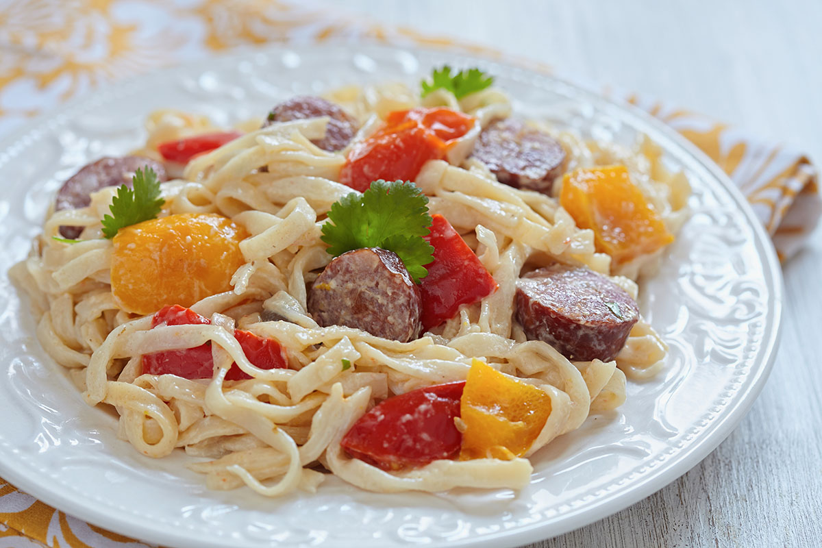 kielbasa pasta on a white plate. 