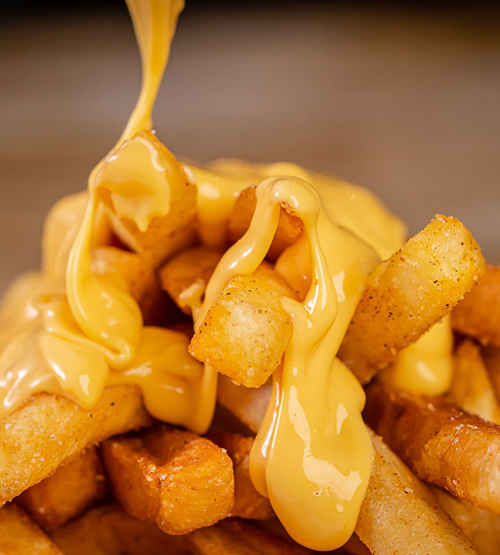 papas fritas with cheese sauce on top.