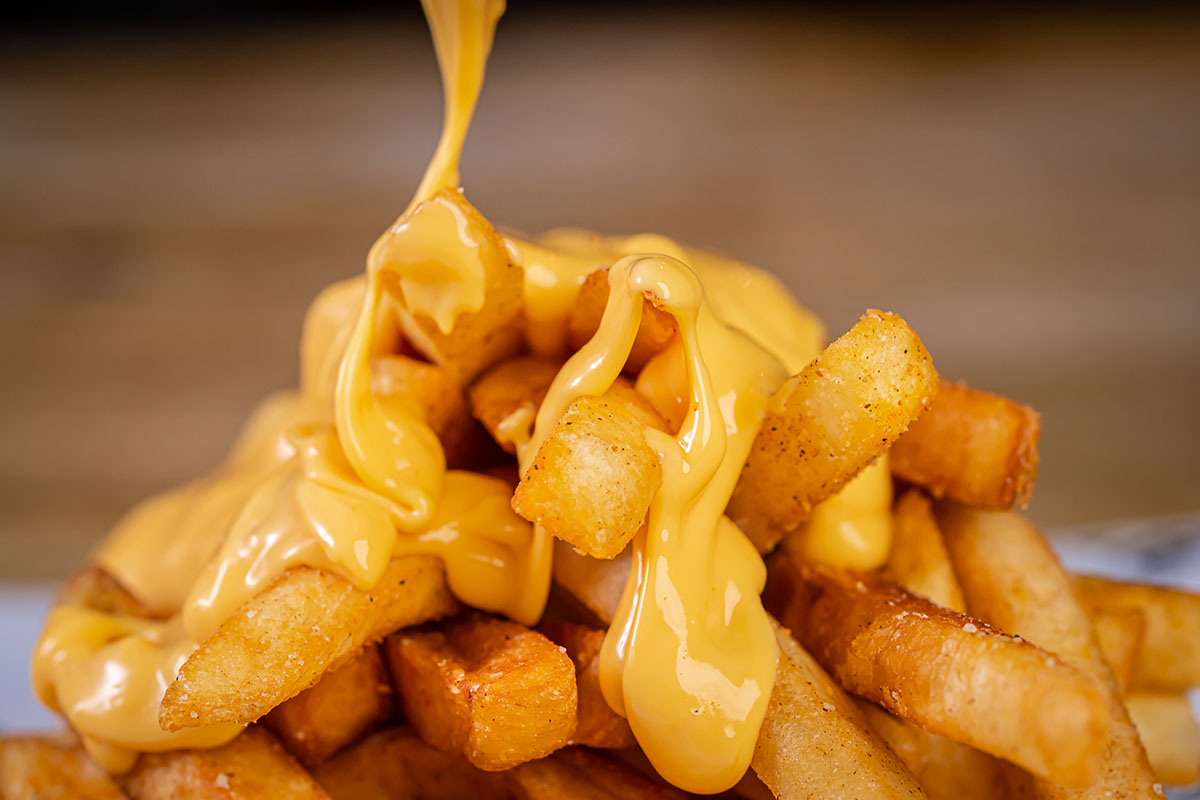 papas fritas with cheese sauce on top. 