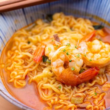 shrimp ramen in a bowl with chopsticks on the side.