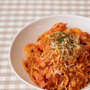 spicy chicken pasta in a white bowl.