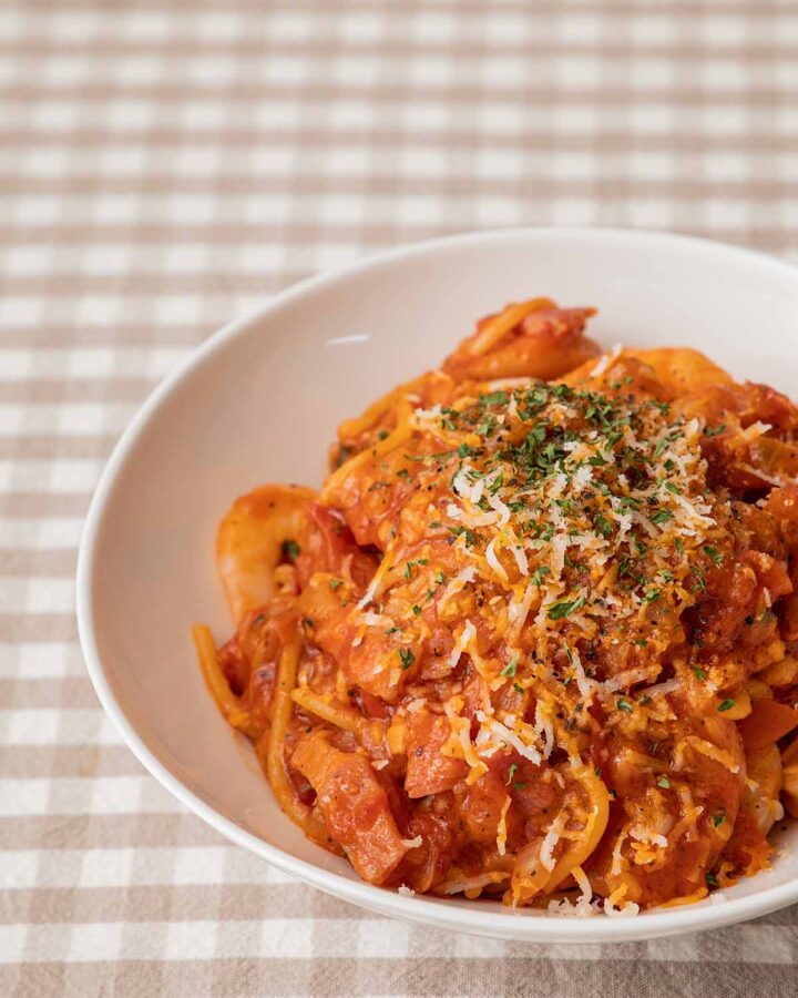 spicy chicken pasta in a white bowl.