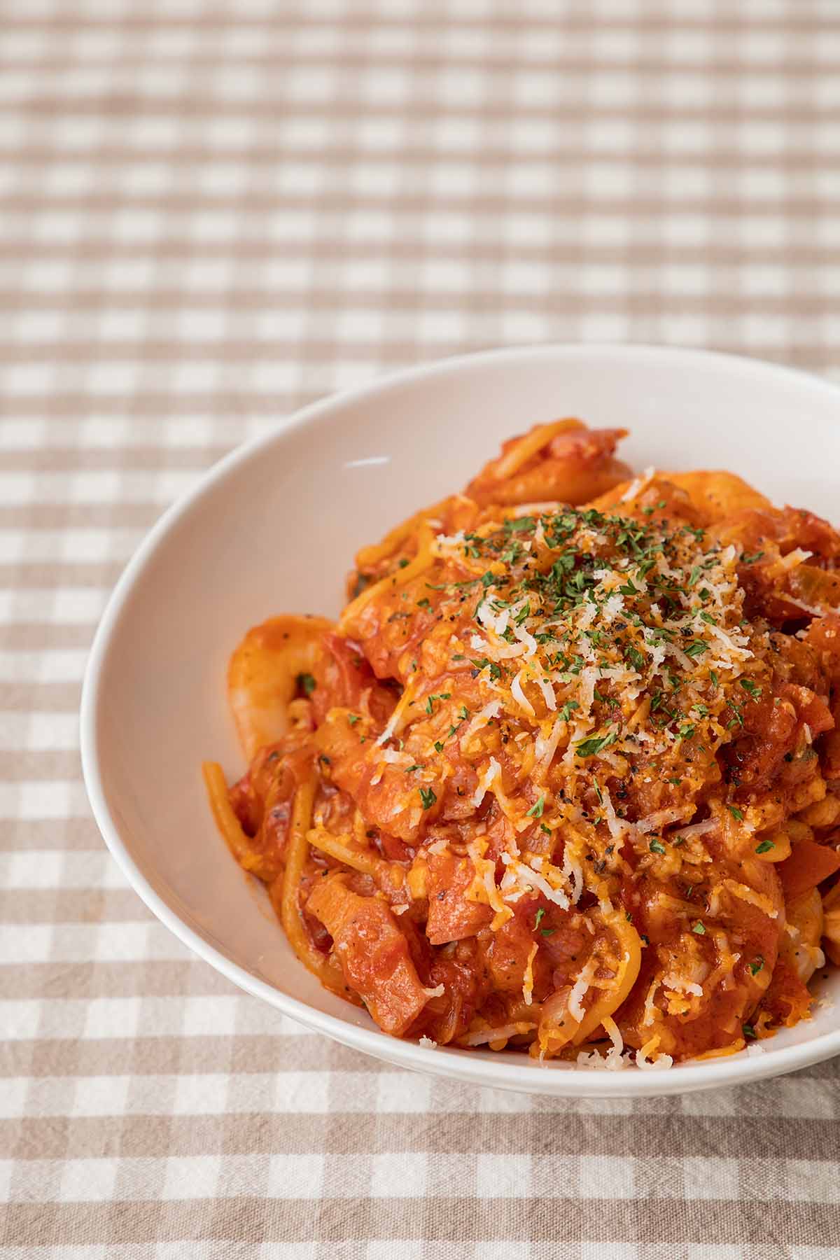 spicy chicken pasta in a white bowl.