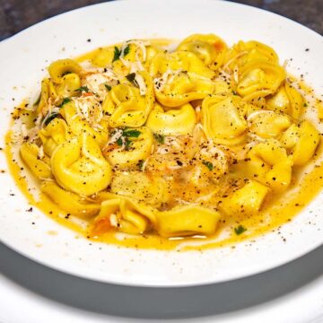 chicken tortellini in a white bowl.