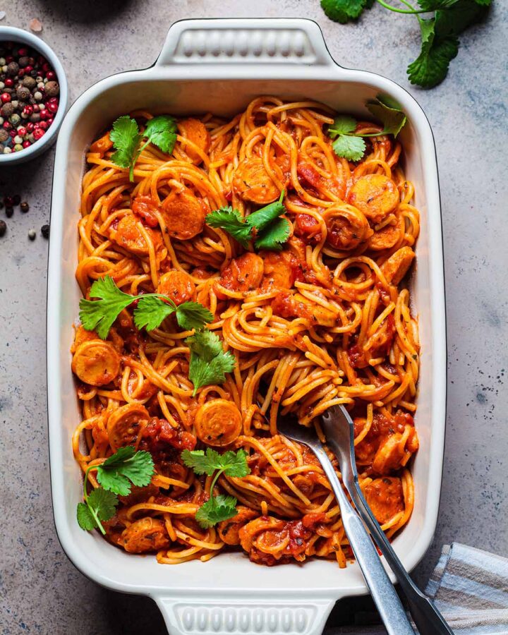 Linguica spaghetti in a white baking dish.