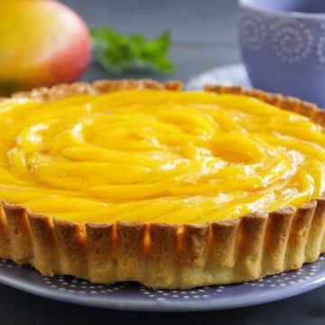 mango peach pie on a plate.
