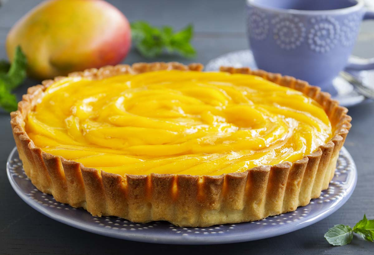 mango peach pie on a plate.