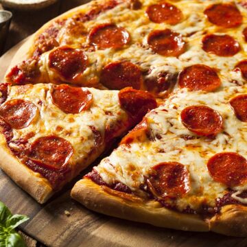 pepperoni pizza on a wooden board.