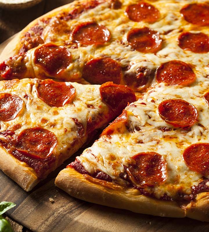 pepperoni pizza on a wooden board.